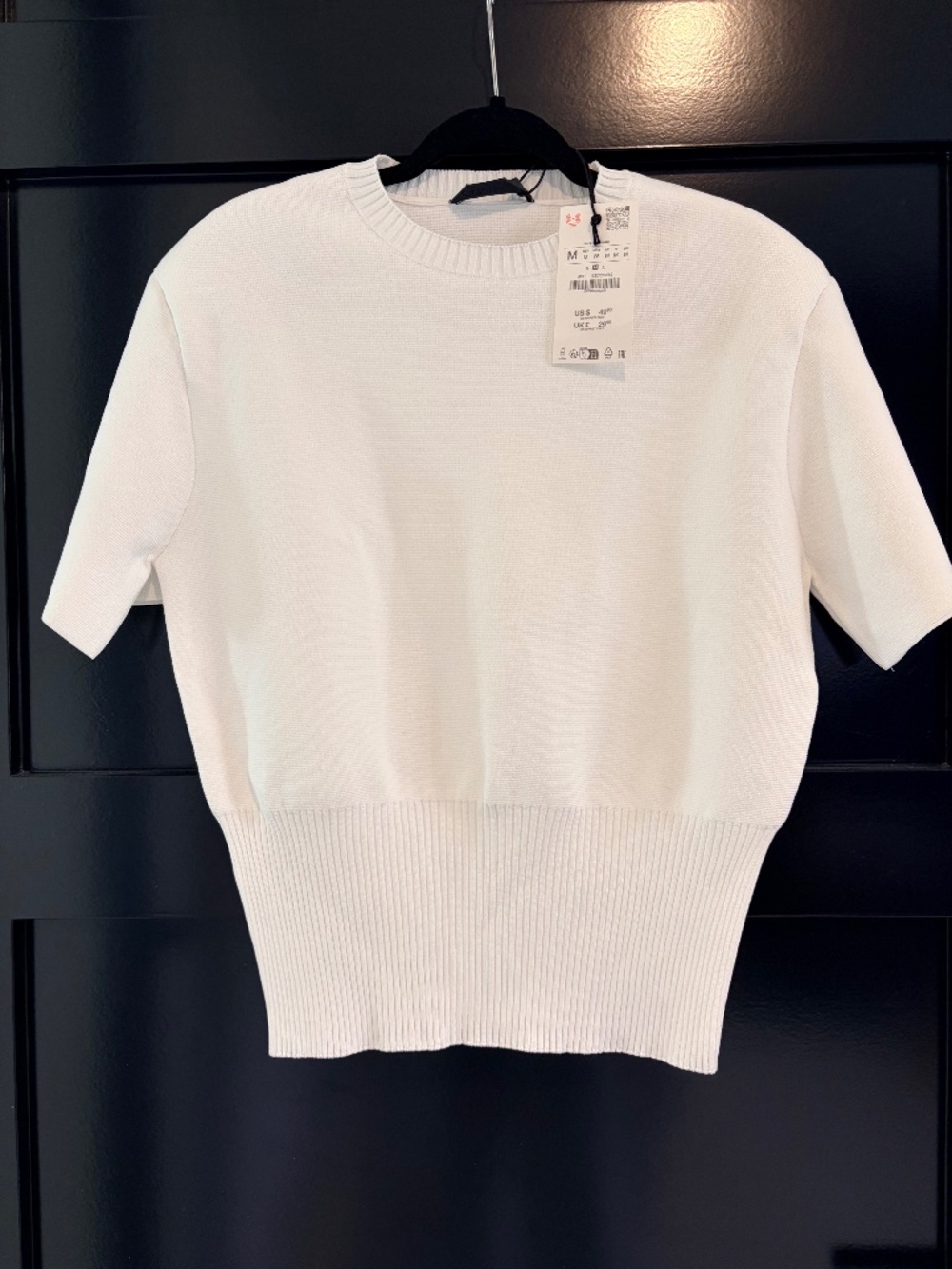 White sweater shoulder pad knit top